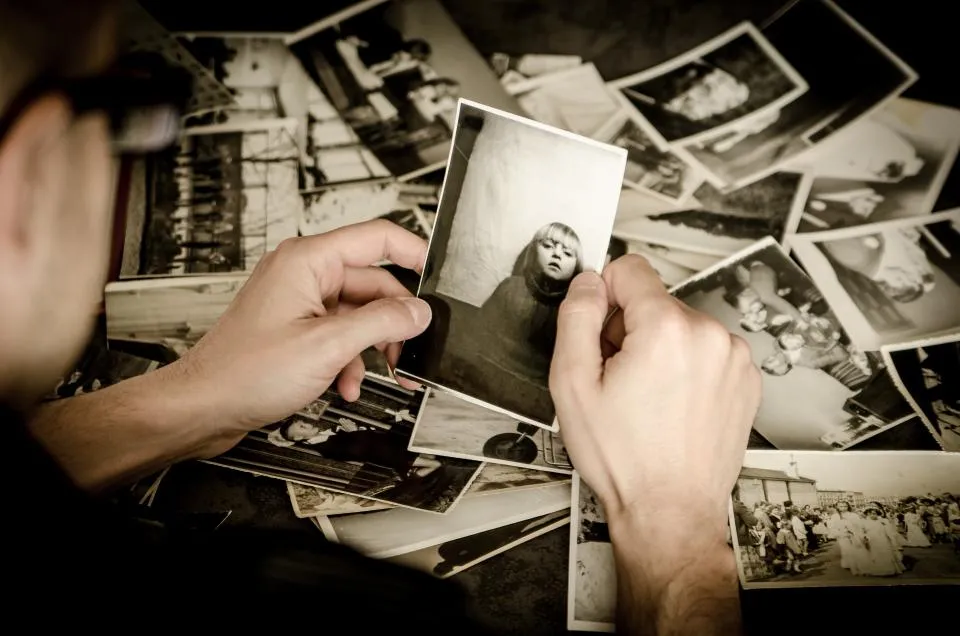 Mãos segurando fotografias antigas de família